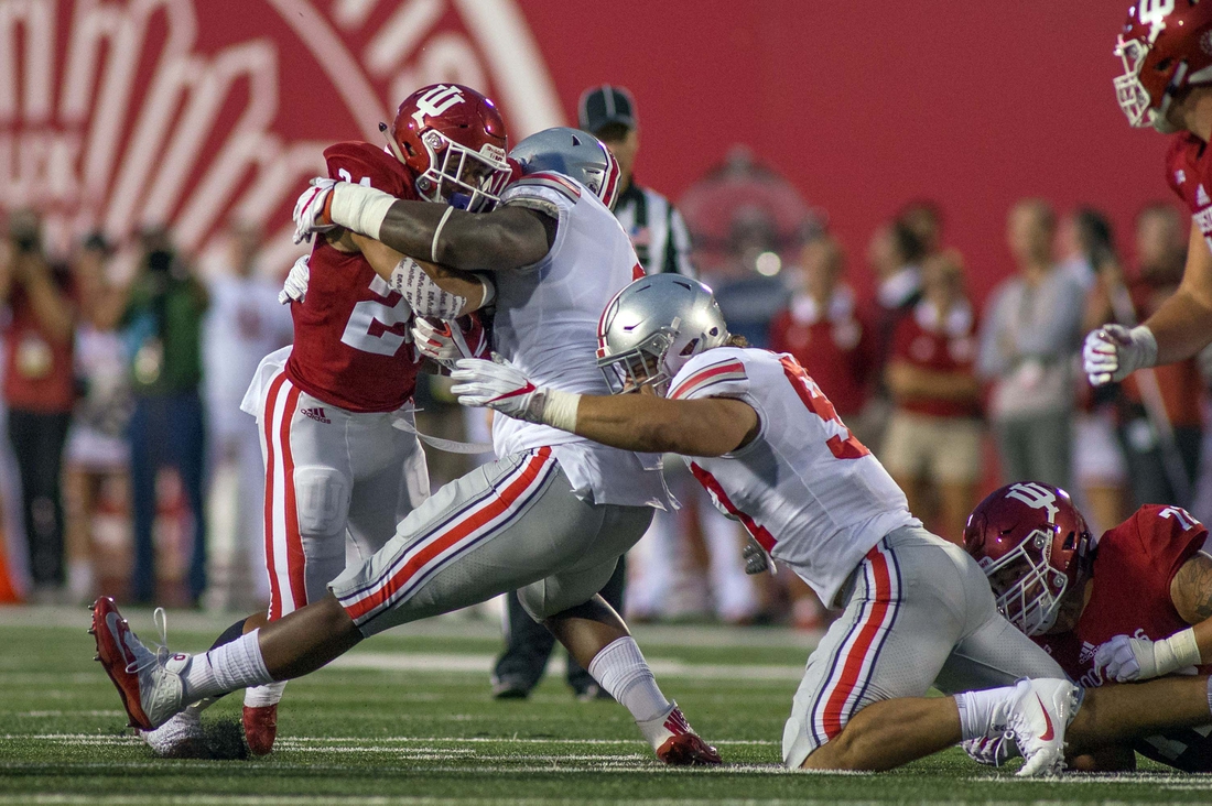 Aug 31, 2017; Bloomington, IN, USA; Indiana Hoosiers running back Mike Majette (24) rushes the ball and is tackled by Ohio State Buckeyes defensive lineman Haskell Garrett (92) and defensive lineman Jerron Cage (98) in the first quarter of the game at Memorial Stadium. Mandatory Credit: Trevor Ruszkowski-USA TODAY Sports