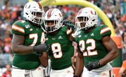 Nov 9, 2019; Miami Gardens, FL, USA; Miami Hurricanes wide receiver Dee Wiggins (center) celebrates with offensive lineman John Campbell Jr. (left) and running back Robert Burns (right) after scoring a touchdown against the Louisville Cardinals during the first half at Hard Rock Stadium. Mandatory Credit: Steve Mitchell-USA TODAY Sports