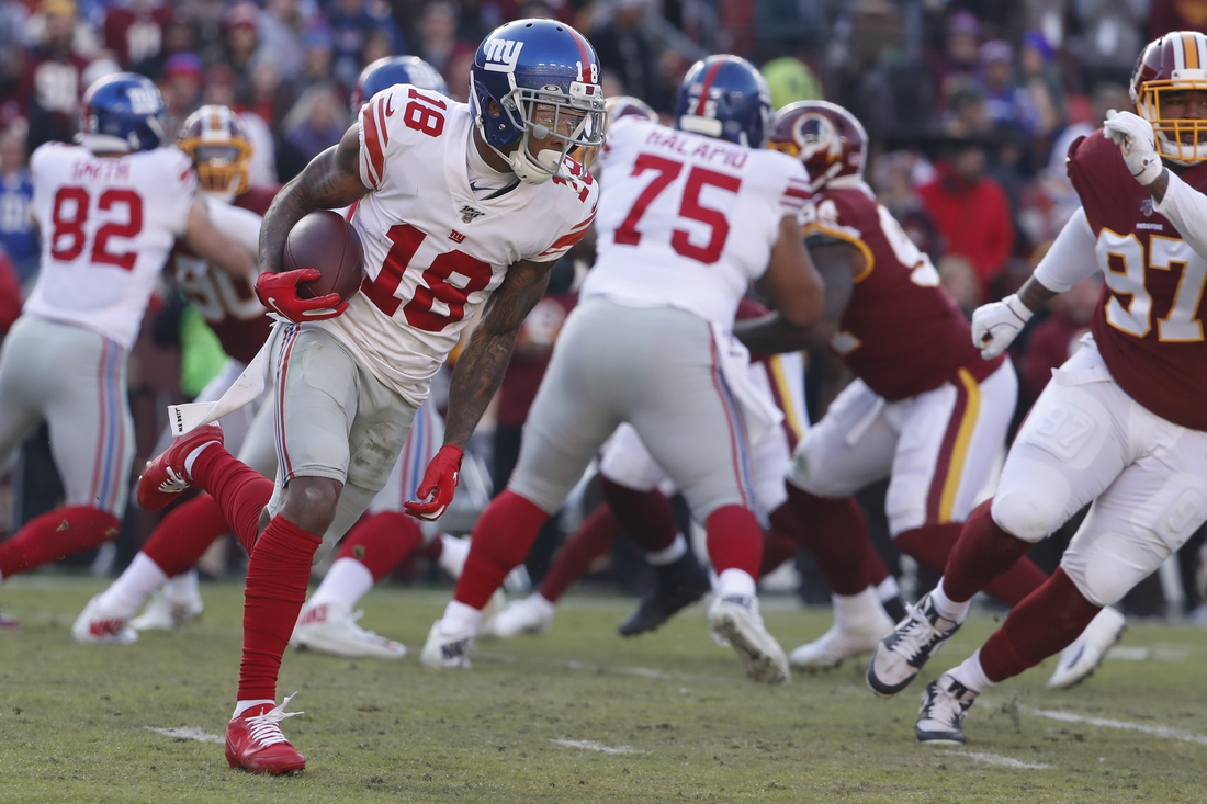 Dec 22, 2019; Landover, Maryland, USA; New York Giants wide receiver Da'Mari Scott (18) runs with the ball as Washington Redskins defensive tackle Tim Settle (97) chases in the second quarter at FedExField. Mandatory Credit: Geoff Burke-USA TODAY Sports
