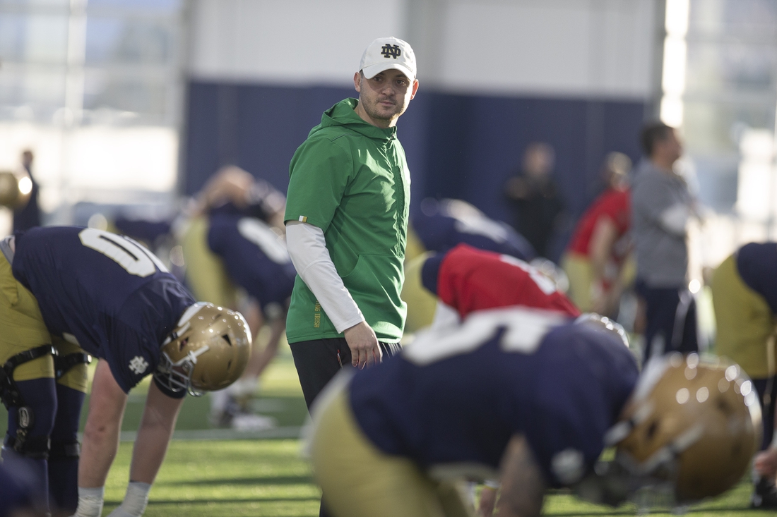 March 5, 2020; South Bend, IN, USA; Notre Dame offensive coordinator Tommy Rees walks amongst the players during Notre Dame's first spring football practice at the Irish Athletics Center. Mandatory Credit: Santiago Flores/South Bend Tribune via USA TODAY NETWORK