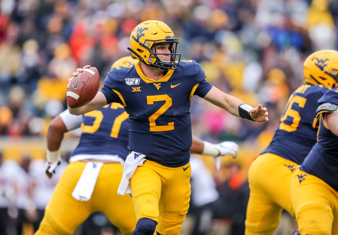 Nov 23, 2019; Morgantown, WV, USA; West Virginia Mountaineers quarterback Jarret Doege (2) throws a pass during the third quarter against the Oklahoma State Cowboys at Mountaineer Field at Milan Puskar Stadium. Mandatory Credit: Ben Queen-USA TODAY Sports