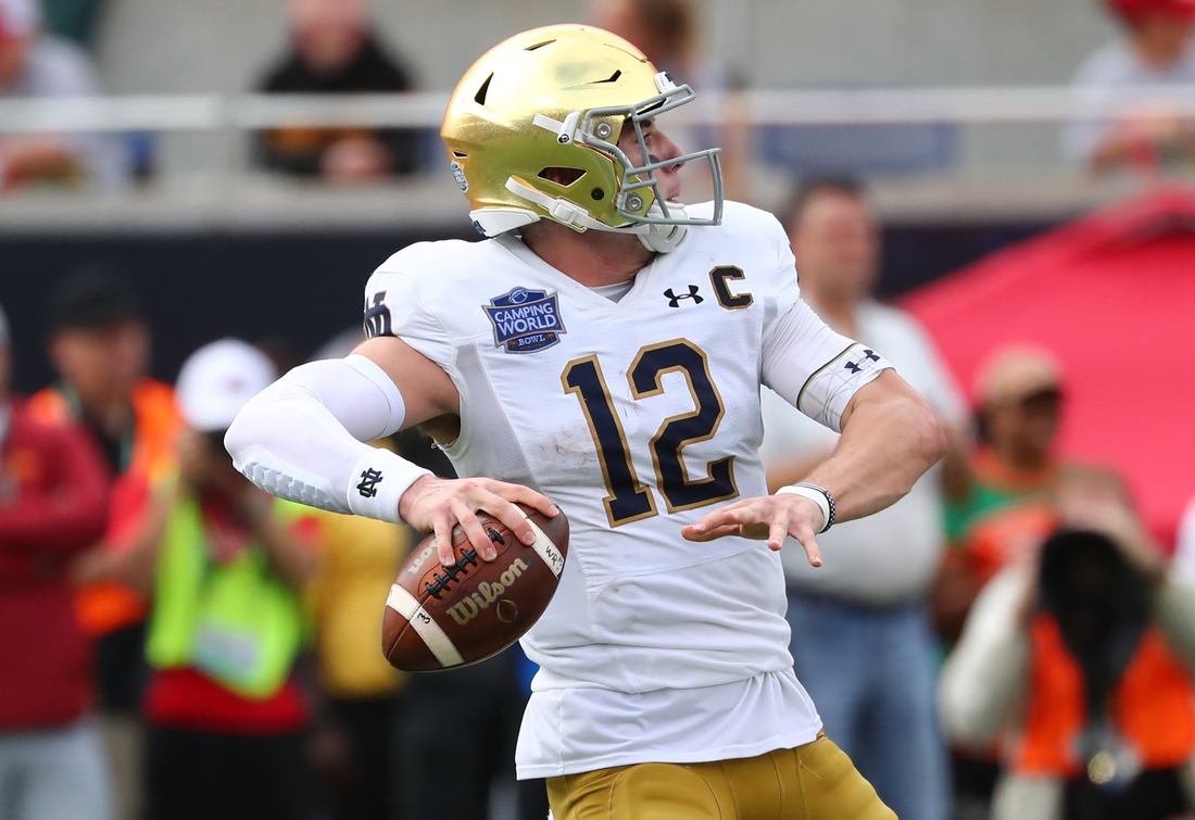 Dec 28, 2019; Orlando, Florida, USA; Notre Dame Fighting Irish quarterback Ian Book (12) throws the ball against the Iowa State Cyclones during the second half at Camping World Stadium. Mandatory Credit: Kim Klement-USA TODAY Sports