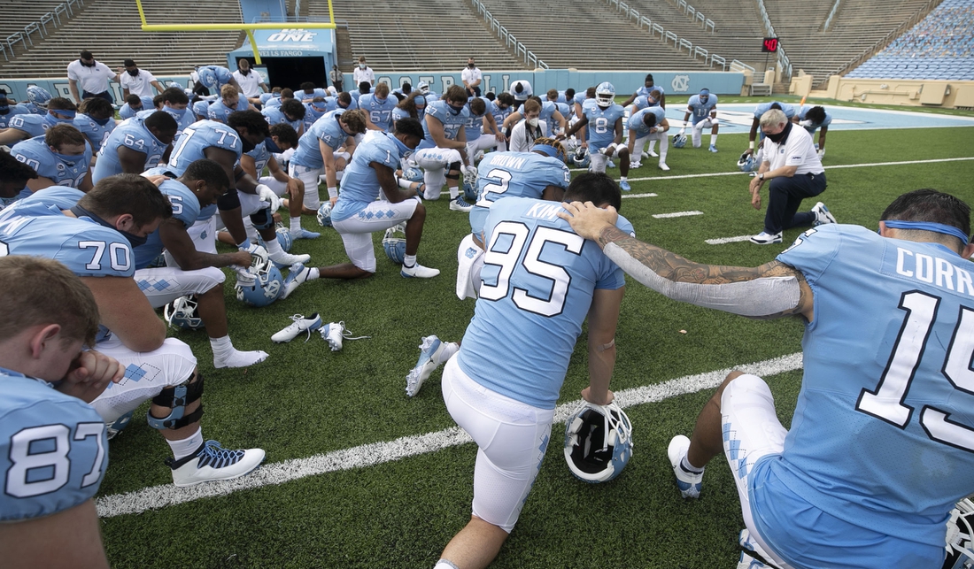 Sept 12, 2020, Chapel Hill, NC, USA; North Carolina coach Mack Brown and his team pray following their 31-6 victory over Syracuse at Kenan Stadium on Saturday, September 12, 2020 in Chapel Hill, N.C.. Mandatory credit: Robert Willett/Pool Photo via USA TODAY Sports