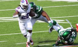 Sep 13, 2020; Orchard Park, New York, USA; Buffalo Bills running back Zack Moss (20) runs with the ball in front of New York Jets defensive tackles Nathan Shepherd (97) and Steve McLendon (99) during the third quarter at Bills Stadium. Mandatory Credit: Rich Barnes-USA TODAY Sports