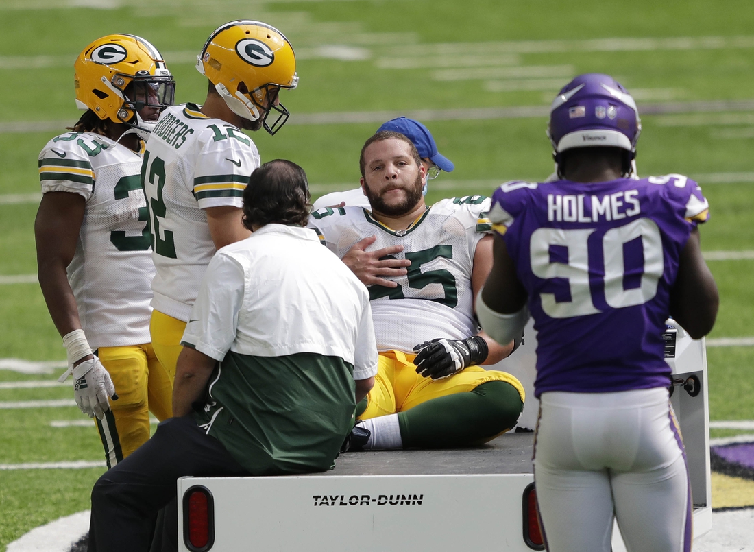 Sep 13, 2020; Minneapolis, MN, USA; Green Bay Packers quarterback Aaron Rodgers (12) checks on guard Lane Taylor (65) after he was injured against the Minnesota Vikings during their football game Sunday, September 13, 2020, at U.S. Bank Stadium in Minneapolis, Minn. Green Bay won 43-34.  Mandatory Credit: Dan Powers/Appleton Post-Crescsent-USA TODAY NETWORK