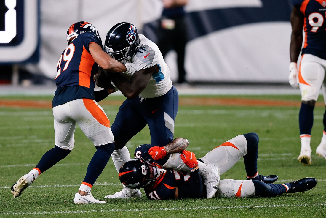 Sep 14, 2020; Denver, Colorado, USA; Tennessee Titans wide receiver A.J. Brown (11) is tackled by Denver Broncos free safety Justin Simmons (31) and cornerback Bryce Callahan (29) in the third quarter at Empower Field at Mile High. Mandatory Credit: Isaiah J. Downing-USA TODAY Sports
