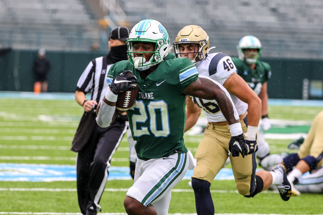 Sep 19, 2020; New Orleans, Louisiana, USA; Tulane Green Wave running back Cameron Carroll (20) runs past Navy Midshipmen linebacker Tommy Lawley (46) for a touchdown during the first half at Yulman Stadium. Mandatory Credit: Derick E. Hingle-USA TODAY Sports