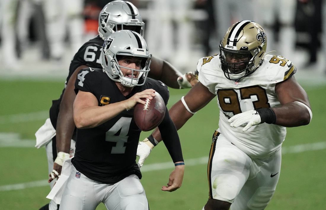 Sep 21, 2020; Paradise, Nevada, USA;  Las Vegas Raiders quarterback Derek Carr (4) runs away from New Orleans Saints defensive tackle David Onyemata (93) during the second quarter of a NFL game at Allegiant Stadium. Mandatory Credit: Kirby Lee-USA TODAY Sports