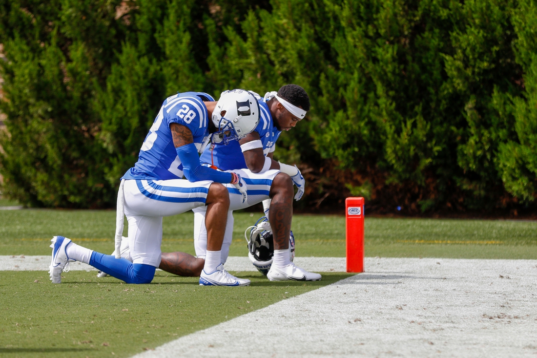 Sep 19, 2020; Durham, North Carolina, USA; Duke Blue Devils cornerback Mark Gilbert (28) kneels with a teammate before the start of an NCAA football game against the Boston College Eagles at Wallace Wade Stadium. The Boston College Eagles won 26-6. Mandatory Credit: Nell Redmond-USA TODAY Sports
