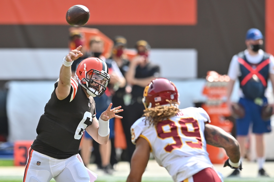 Sep 27, 2020; Cleveland, Ohio, USA; Cleveland Browns quarterback Baker Mayfield (6) throws a pass over Washington Football Team defensive end Chase Young (99) during the first quarter at FirstEnergy Stadium. Mandatory Credit: Ken Blaze-USA TODAY Sports