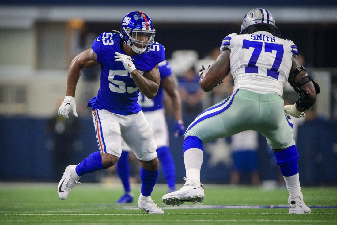 Sep 8, 2019; Arlington, TX, USA; New York Giants linebacker Oshane Ximines (53) and Dallas Cowboys offensive tackle Tyron Smith (77) in action during the game between the Cowboys and the Giants at AT&T Stadium. Mandatory Credit: Jerome Miron-USA TODAY Sports