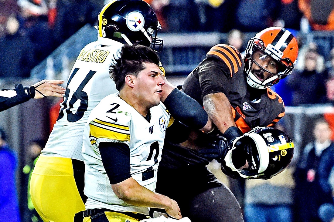 Nov 14, 2019; Cleveland, OH, USA; Cleveland Browns defensive end Myles Garrett (95) hits Pittsburgh Steelers quarterback Mason Rudolph (2) with his own helmet as offensive guard David DeCastro (66) tries to stop Garrett during the fourth quarter at FirstEnergy Stadium. Mandatory Credit: Ken Blaze-USA TODAY Sports