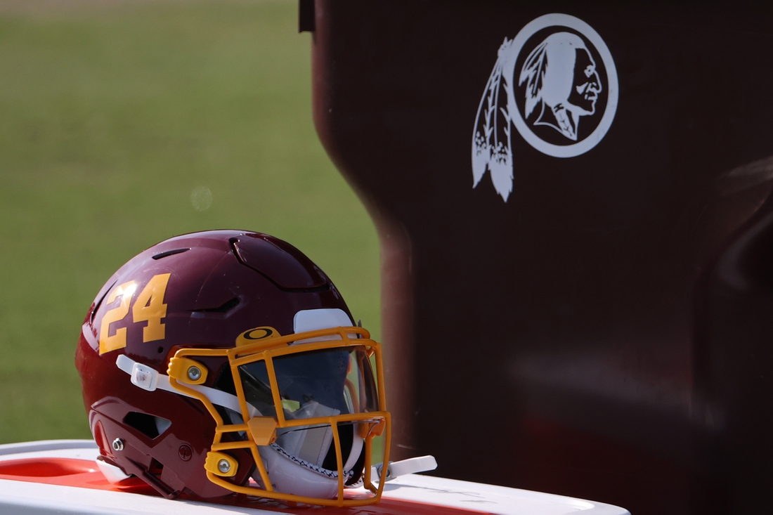 Aug 20, 2020; Ashburn, Virginia, USA; The helmet of Washington Football Team running back Antonio Gibson (not pictured) rests on a cooler next to a trashcan with the retired Washington Redskins logo on day twenty-three of training camp at Inova Sports Performance Center in Ashburn, Virginia. Mandatory Credit: Geoff Burke-USA TODAY Sports