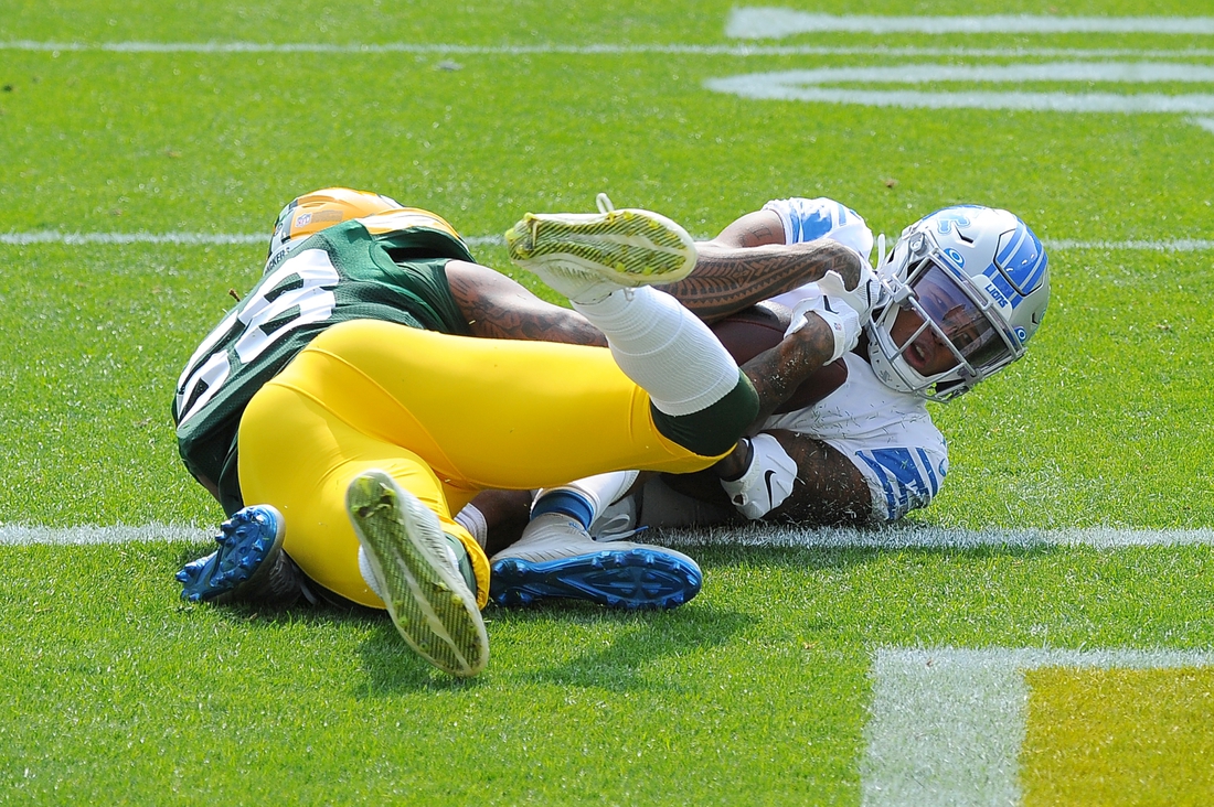 Sep 20, 2020; Green Bay, Wisconsin, USA;  Detroit Lions wide receiver Marvin Jones (11) catches a touchdown pass while being defended by Green Bay Packers outside linebacker Christian Kirksey (58) in the first quarter at Lambeau Field. Mandatory Credit: Michael McLoone-USA TODAY Sports