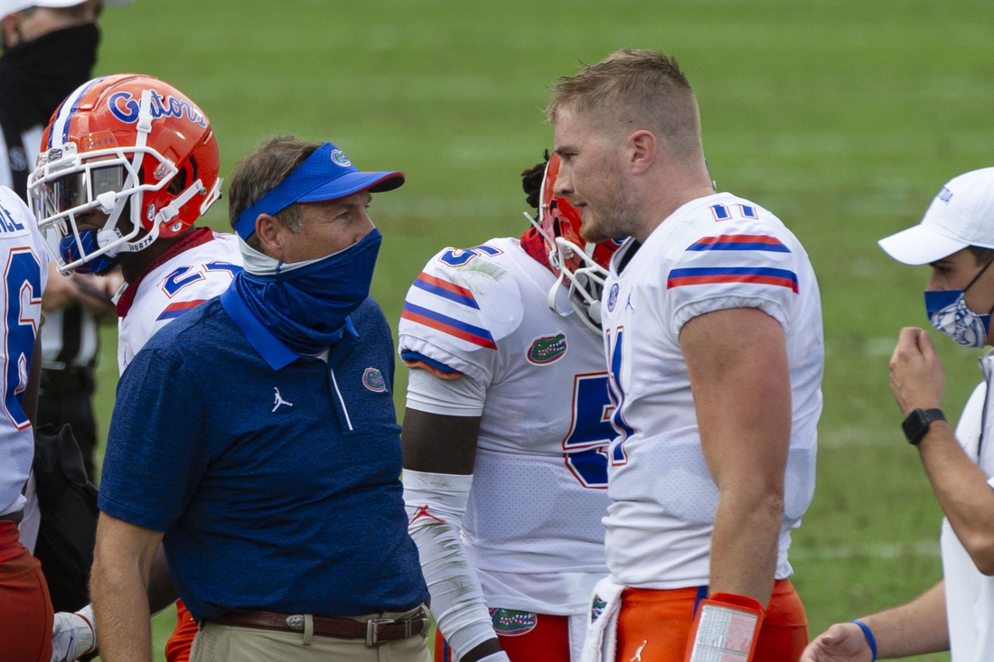 Sep 26, 2020; Oxford, Mississippi, USA; Florida Gators head coach Dan Mullen and Florida Gators quarterback Kyle Trask (11) during the first half against the Mississippi Rebels  at Vaught-Hemingway Stadium. Mandatory Credit: Justin Ford-USA TODAY Sports