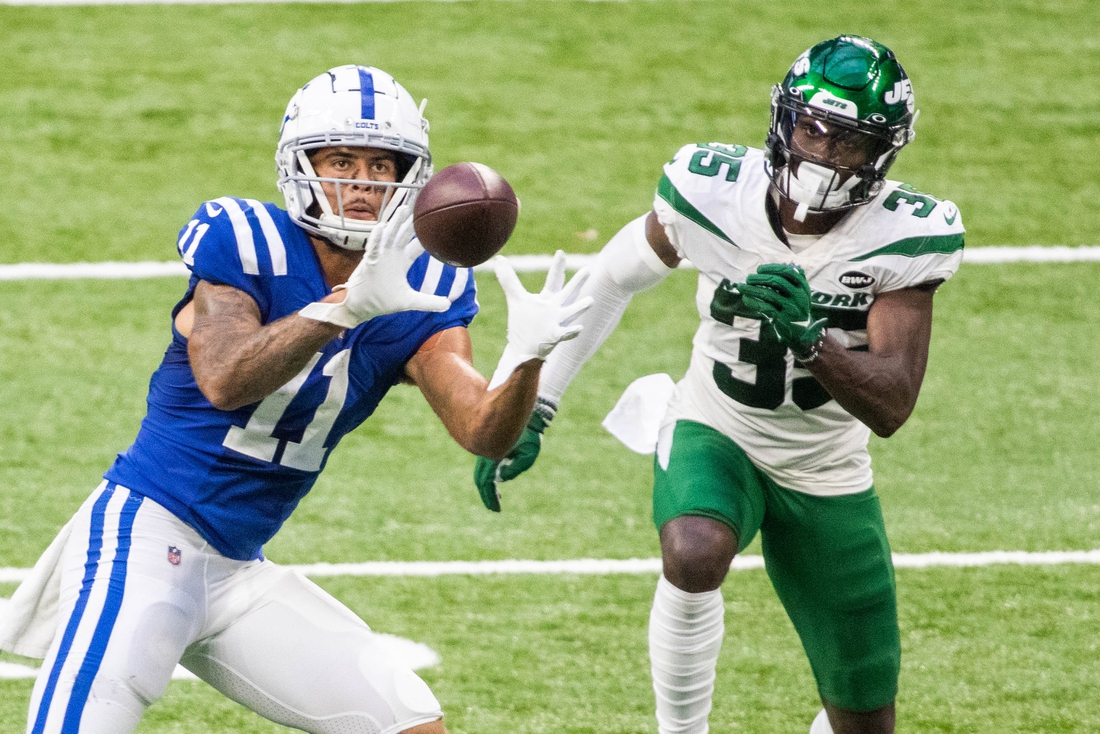 Sep 27, 2020; Indianapolis, Indiana, USA; Indianapolis Colts wide receiver Michael Pittman (11) catches the ball while New York Jets cornerback Pierre Desir (35) defends in the second half at Lucas Oil Stadium. Mandatory Credit: Trevor Ruszkowski-USA TODAY Sports