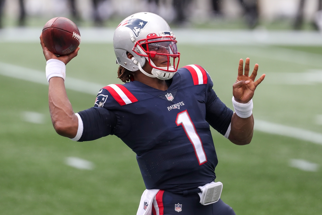 Sep 27, 2020; Foxborough, Massachusetts, USA; New England Patriots quarterback Cam Newton (1) throws a pass to warm up between plays during the first half against the Las Vegas Raiders at Gillette Stadium. Mandatory Credit: Paul Rutherford-USA TODAY Sports