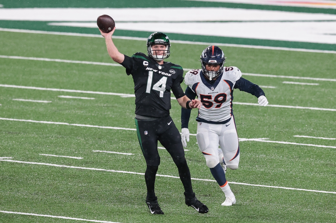 Oct 1, 2020; East Rutherford, New Jersey, USA; New York Jets quarterback Sam Darnold (14) throws the ball as Denver Broncos linebacker Malik Reed (59) pursues during the second half at MetLife Stadium. Mandatory Credit: Vincent Carchietta-USA TODAY Sports