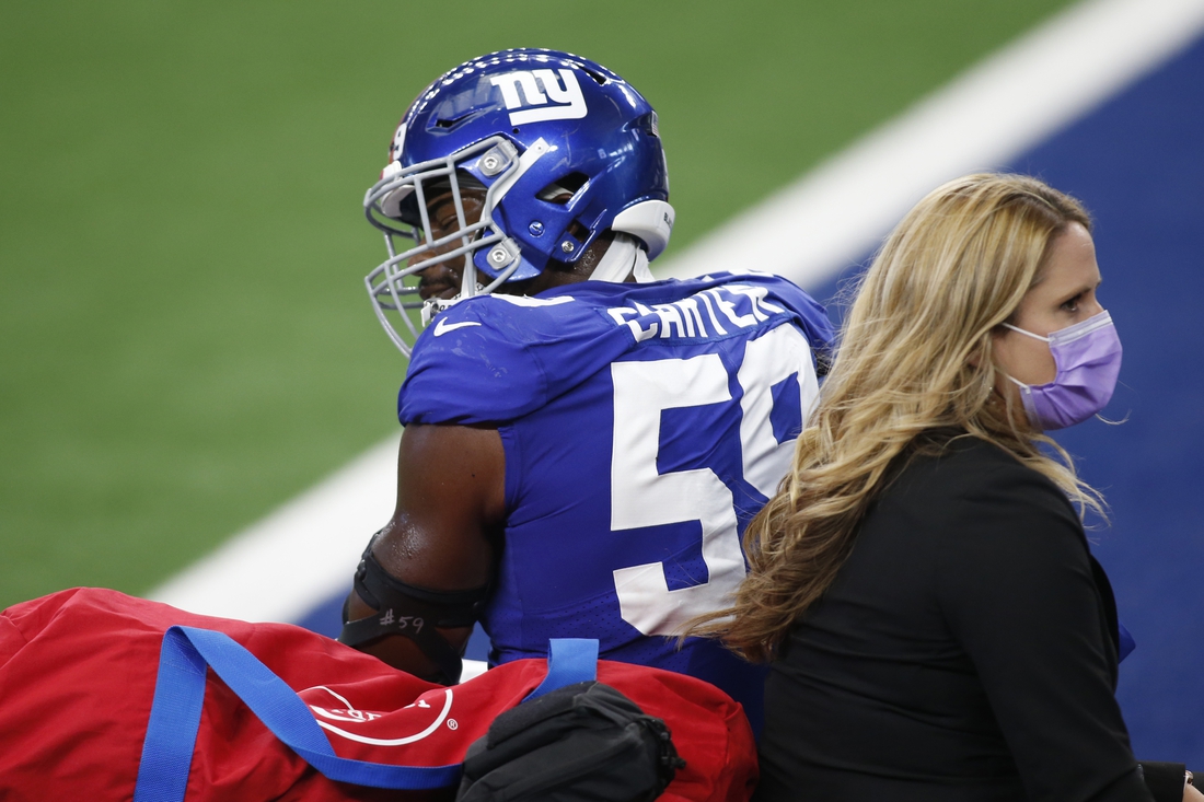 Oct 11, 2020; Arlington, Texas, USA; New York Giants outside linebacker Lorenzo Carter (59) is carted off the field in the first quarter against the Dallas Cowboys at AT&T Stadium. Mandatory Credit: Tim Heitman-USA TODAY Sports