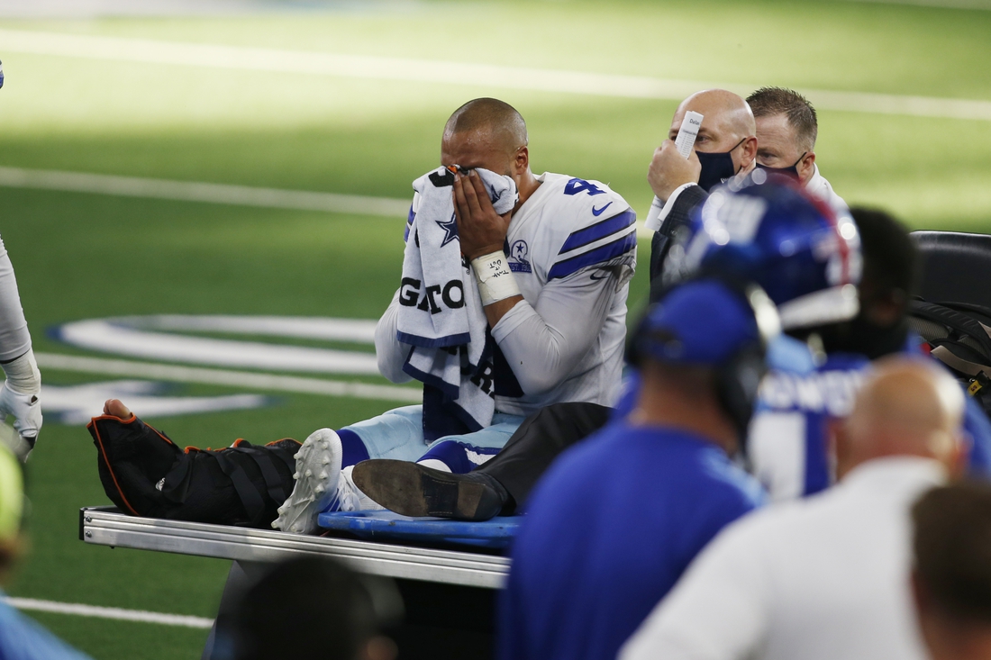 Oct 11, 2020; Arlington, Texas, USA; Dallas Cowboys quarterback Dak Prescott (4) leaves the field with an injury in the third quarter against the New York Giants at AT&T Stadium. Mandatory Credit: Tim Heitman-USA TODAY Sports