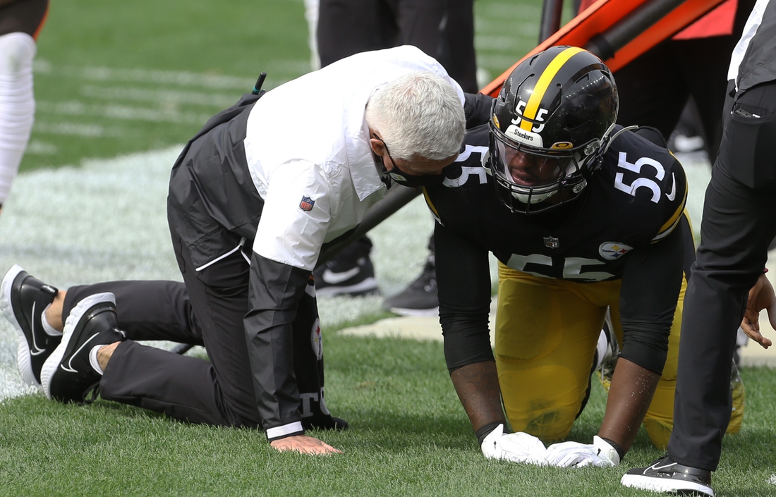Oct 18, 2020; Pittsburgh, Pennsylvania, USA;  Pittsburgh Steelers inside linebacker Devin Bush (55) is assisted by a team trainer after suffering an apparent injury that forced him to leave the game against the Cleveland Browns during the second quarter at Heinz Field.  Mandatory Credit: Charles LeClaire-USA TODAY Sports
