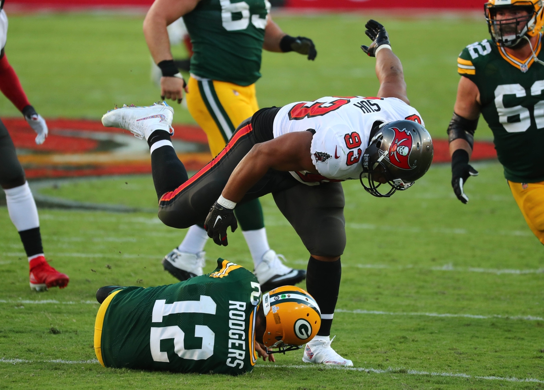 Oct 18, 2020; Tampa, Florida, USA; Tampa Bay Buccaneers defensive end Ndamukong Suh (93) sacks Green Bay Packers quarterback Aaron Rodgers (12) during the second quarter of a NFL game at Raymond James Stadium. Mandatory Credit: Kim Klement-USA TODAY Sports