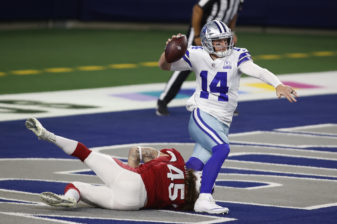 Oct 19, 2020; Arlington, Texas, USA; Arizona Cardinals linebacker Dennis Gardeck (45) tries to tackle Dallas Cowboys quarterback Andy Dalton (14) in the end zone in the first quarter at AT&T Stadium. Mandatory Credit: Tim Heitman-USA TODAY Sports