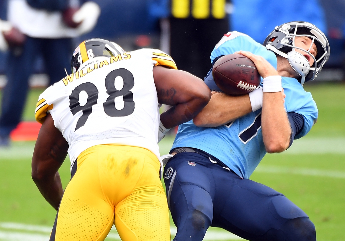 Oct 25, 2020; Nashville, Tennessee, USA; Tennessee Titans quarterback Ryan Tannehill (17) is hit by Pittsburgh Steelers inside linebacker Vince Williams (98) during the first half at Nissan Stadium. Mandatory Credit: Christopher Hanewinckel-USA TODAY Sports