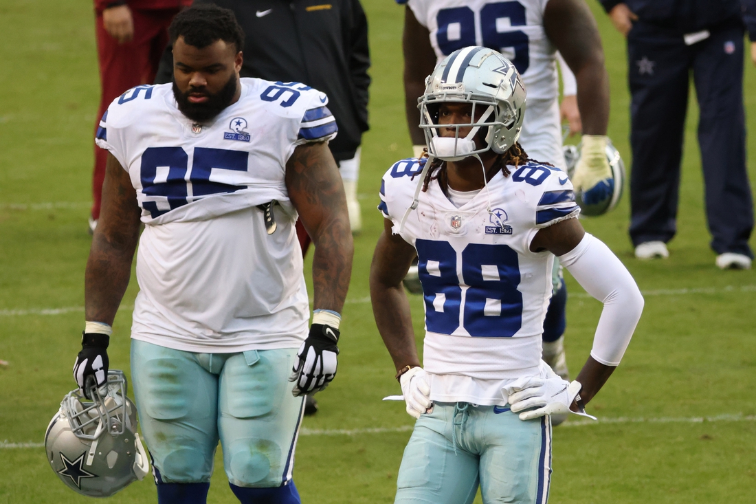 Oct 25, 2020; Landover, Maryland, USA; Dallas Cowboys defensive tackle Dontari Poe (95) and Cowboys wide receiver CeeDee Lamb (88) walk off the field after their game against the Washington Football Team at FedExField. Mandatory Credit: Geoff Burke-USA TODAY Sports