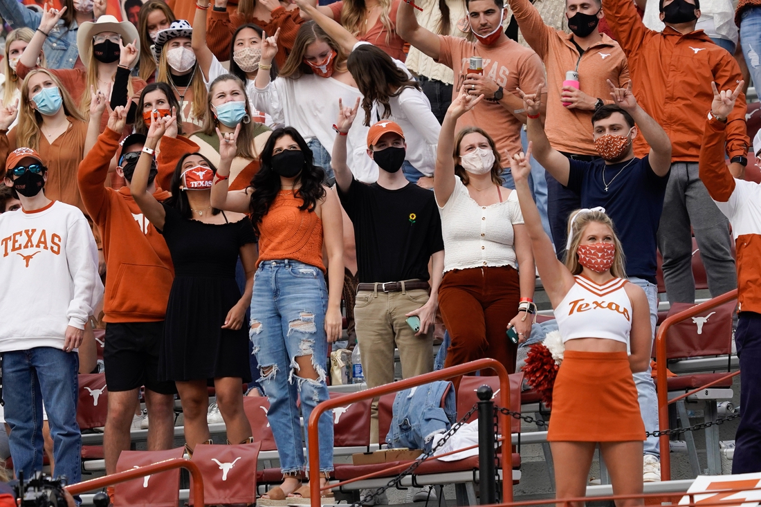 Oct 24, 2020; Austin, Texas, USA; Texas Longhorns fans and Spirit Squad wears masks while cheering on their team from the stands in the third quarter of the game against the Baylor Bears at Darrell K Royal-Texas Memorial Stadium. Mandatory Credit: Scott Wachter-USA TODAY Sports
