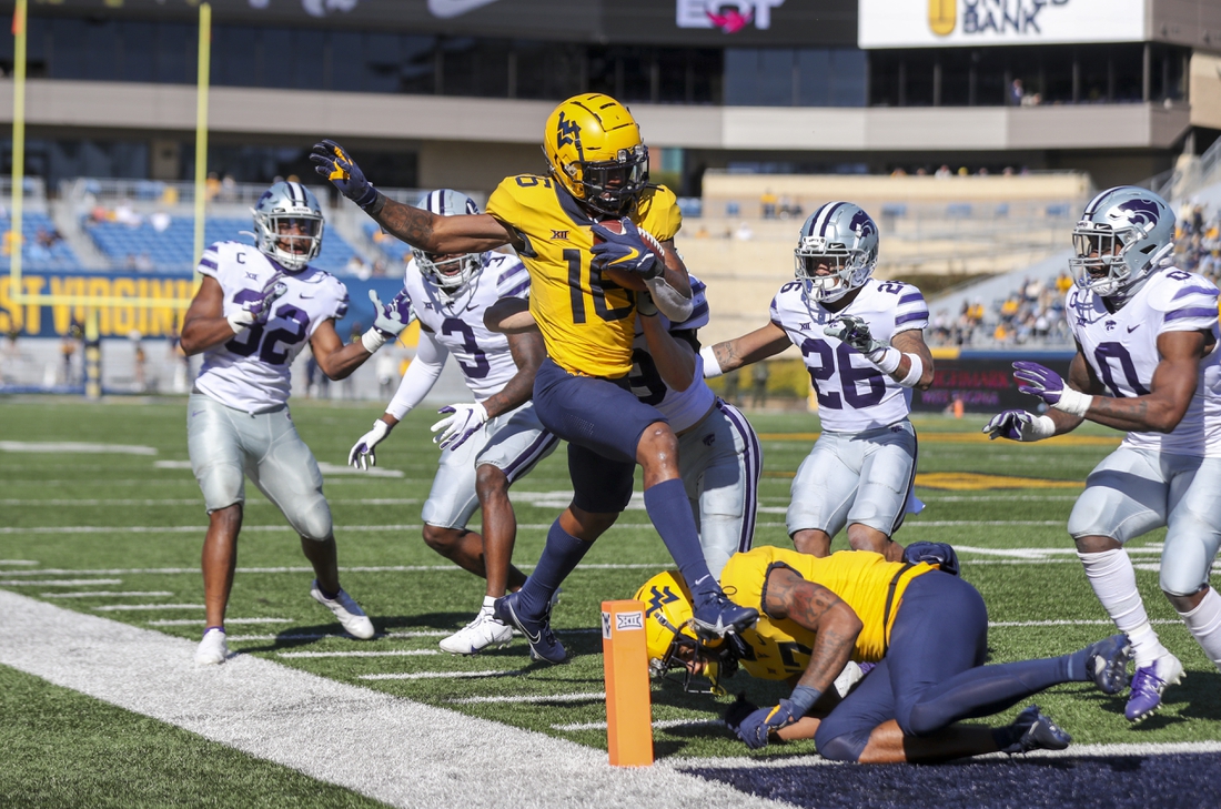 Oct 31, 2020; Morgantown, West Virginia, USA; West Virginia Mountaineers wide receiver Winston Wright Jr. (16) makes a catch and runs for a touchdown during the second quarter against the Kansas State Wildcats at Mountaineer Field at Milan Puskar Stadium. Mandatory Credit: Ben Queen-USA TODAY Sports