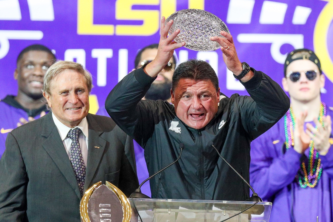 Jan 18, 2020; Baton Rouge, Louisiana, USA;  LSU Tigers head coach Ed Orgeron holds up the AFCA Coaches  Trophy presented by Amway during the LSU championship trophy presentation at Pete Maravich Assembly Center. Mandatory Credit: Stephen Lew-USA TODAY Sports