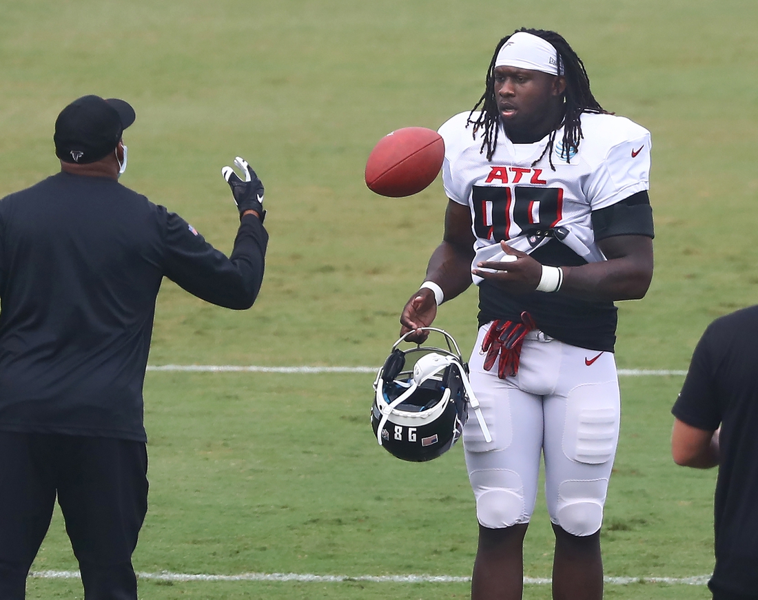 Aug 22, 2020; Flowery Branch, Georgia, USA; Atlanta Falcons defensive end Takk McKinley takes the field and a football for training camp at the Falcons training facility. Mandatory Credit: Curtis Compton/Pool Photo-USA TODAY Sports