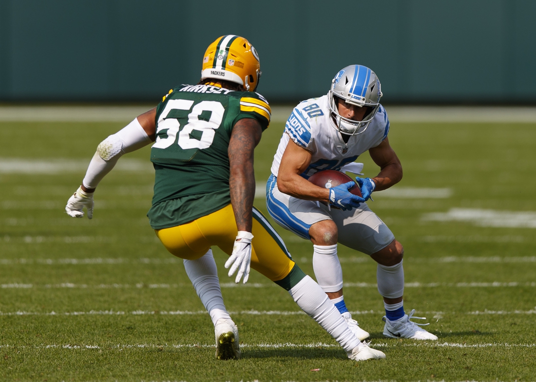 Sep 20, 2020; Green Bay, Wisconsin, USA;  Detroit Lions wide receiver Danny Amendola (80) rushes with the football after catching a pass as Green Bay Packers outside linebacker Christian Kirksey (58) defends during the fourth quarter at Lambeau Field. Mandatory Credit: Jeff Hanisch-USA TODAY Sports