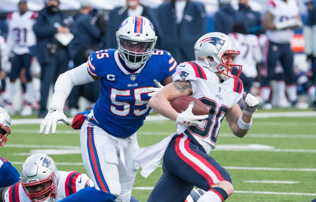 Nov 1, 2020; Orchard Park, New York, USA; New England Patriots wide receiver Gunner Olszewski (80) is chased by Buffalo Bills defensive end Jerry Hughes (55) on a sweep in the second quarter at Bills Stadium. Mandatory Credit: Mark Konezny-USA TODAY Sports