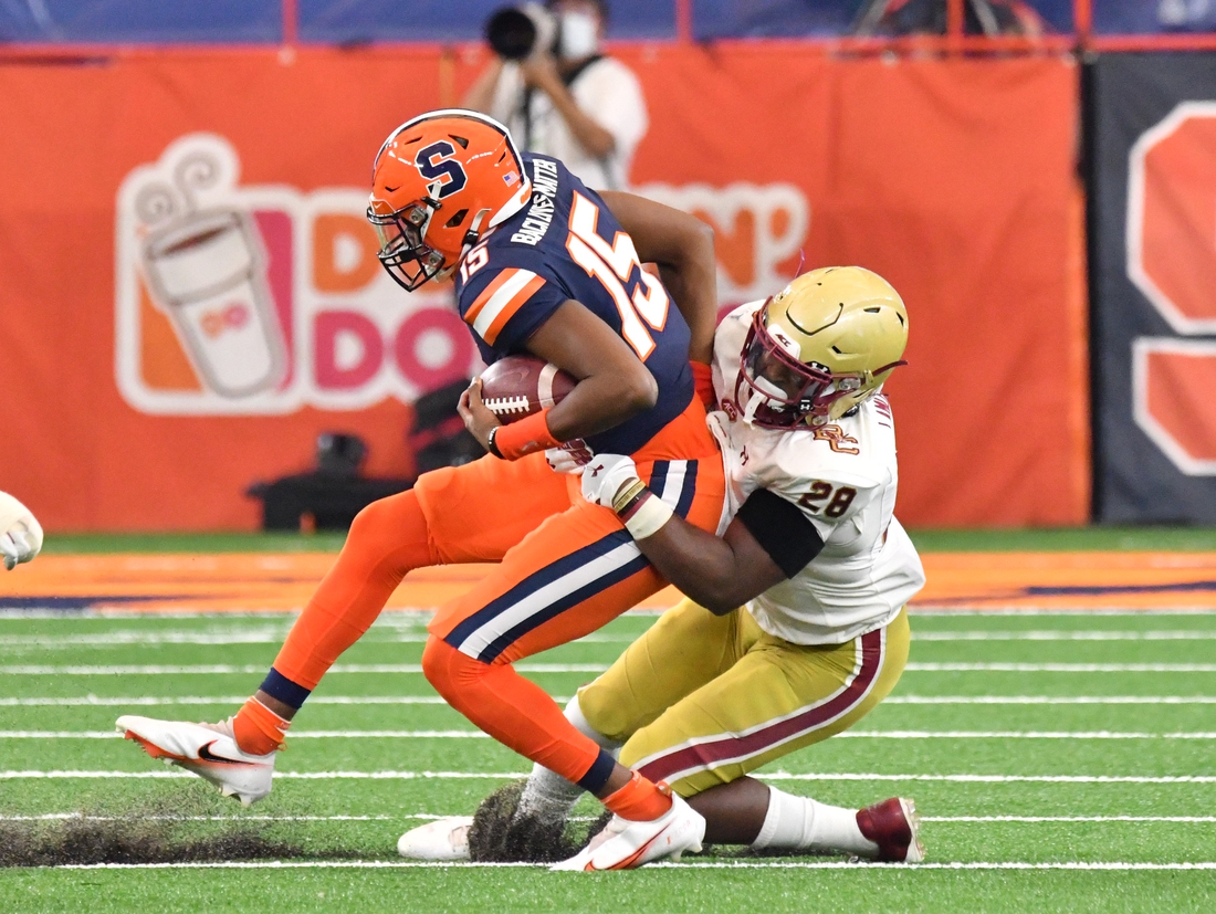 Nov 7, 2020; Syracuse, New York, USA; Syracuse Orange quarterback JaCobian Morgan (15) is tackled by Boston College Eagles linebacker John Lamot (28) in the second quarter at the Carrier Dome. Mandatory Credit: Mark Konezny-USA TODAY Sports