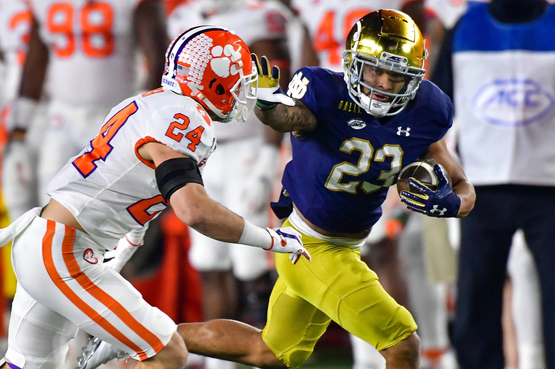 Nov 7, 2020; South Bend, Indiana, USA; Notre Dame Fighting Irish running back Kyren Williams (23) stiff arms Clemson Tigers safety Nolan Turner (24) on his way to a touchdown in the first quarter at Notre Dame Stadium. Mandatory Credit: Matt Cashore-USA TODAY Sports