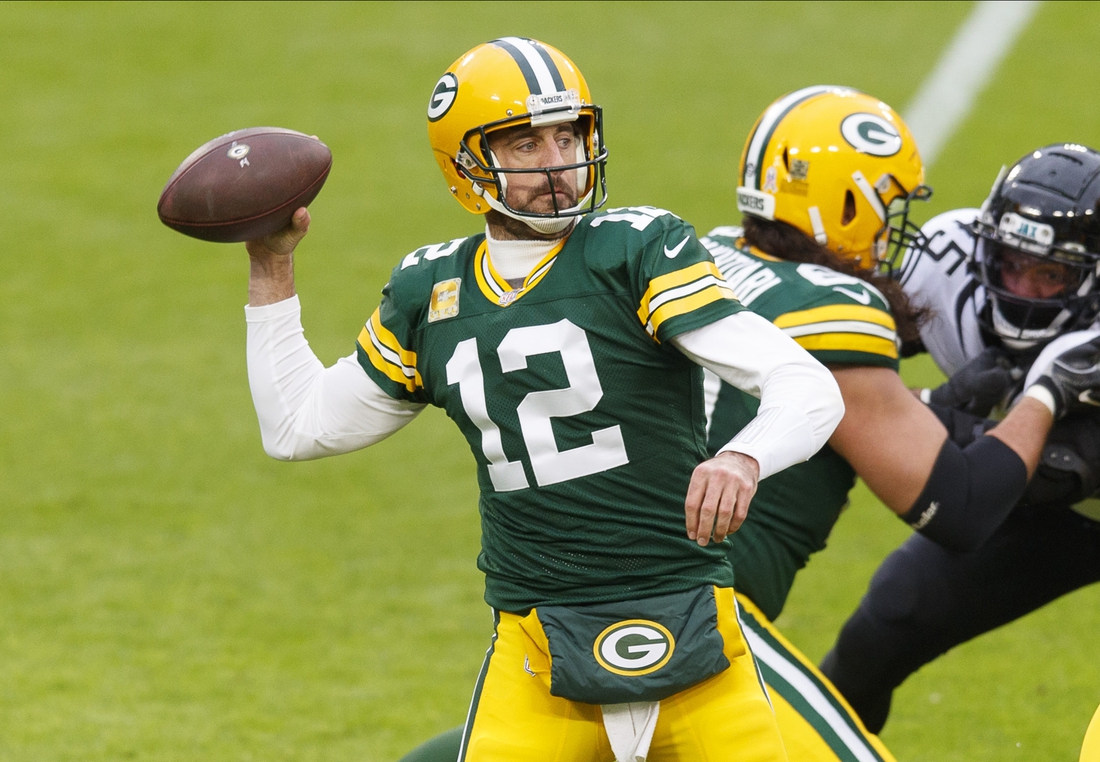 Nov 15, 2020; Green Bay, Wisconsin, USA;  Green Bay Packers quarterback Aaron Rodgers (12) throws a pass against the Jacksonville Jaguars during the second quarter at Lambeau Field. Mandatory Credit: Jeff Hanisch-USA TODAY Sports