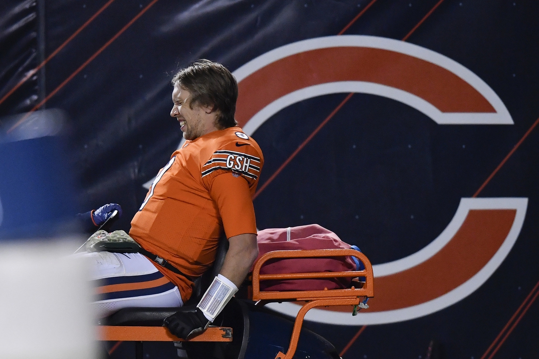 Nov 16, 2020; Chicago, Illinois, USA; Chicago Bears quarterback Nick Foles (9) leaves the game in the second half after an apparent injury against the Minnesota Vikings at Soldier Field. Mandatory Credit: Quinn Harris-USA TODAY Sports