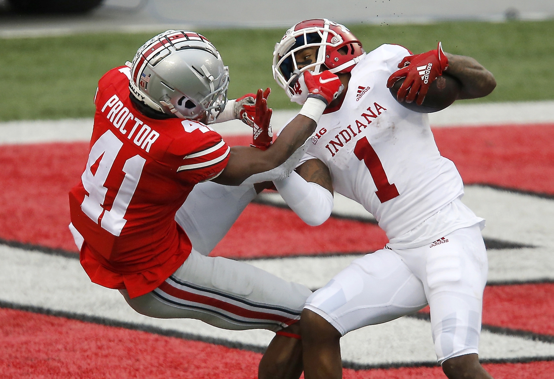 Nov 21, 2020; Columbus, Ohio, USA; Indiana Hoosiers wide receiver Whop Philyor (1) breaks the tackle of Ohio State Buckeyes safety Josh Proctor (41) and scores the touchdown during the second quarter at Ohio Stadium. Mandatory Credit: Joseph Maiorana-USA TODAY Sports