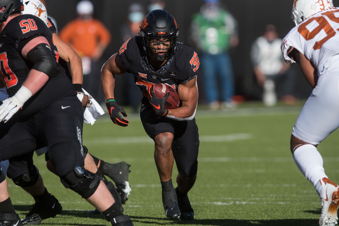 Oct 31, 2020; Stillwater, Oklahoma, USA;  Oklahoma State Cowboys running back Chuba Hubbard (30) runs the ball during the second quarter in the game agains the Texas Longhorns at Boone Pickens Stadium. Texas won 41-34. Mandatory Credit: Brett Rojo-USA TODAY Sports