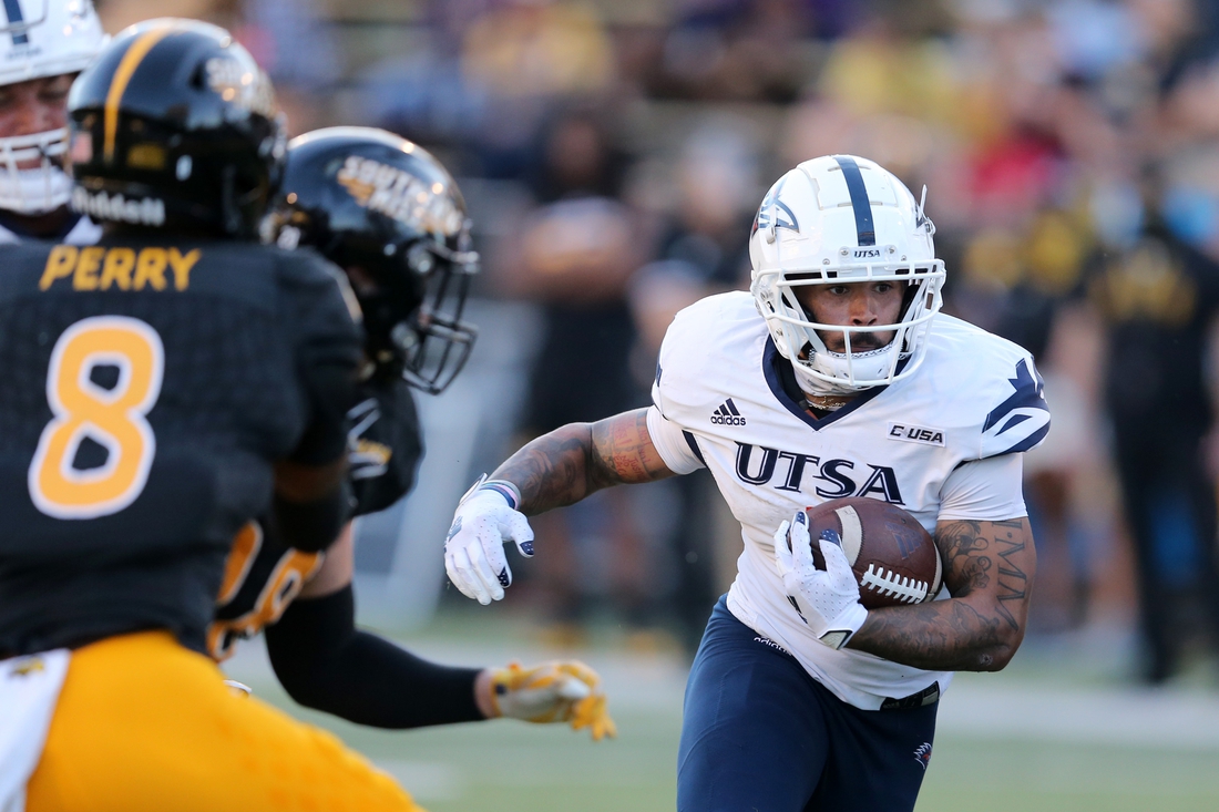 Nov 21, 2020; Hattiesburg, Mississippi, USA; UTSA Roadrunners running back Brenden Brady (5) runs the ball while defended by Southern Miss Golden Eagles defensive back Josh Perry (8) in the second half at M.M. Roberts Stadium. Mandatory Credit: Chuck Cook-USA TODAY Sports