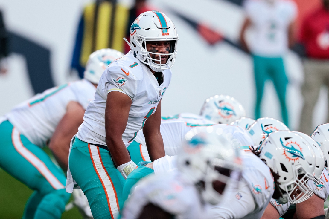 Nov 22, 2020; Denver, Colorado, USA; Miami Dolphins quarterback Tua Tagovailoa (1) at the line of scrimmage in the third quarter against the Denver Broncos at Empower Field at Mile High. Mandatory Credit: Isaiah J. Downing-USA TODAY Sports