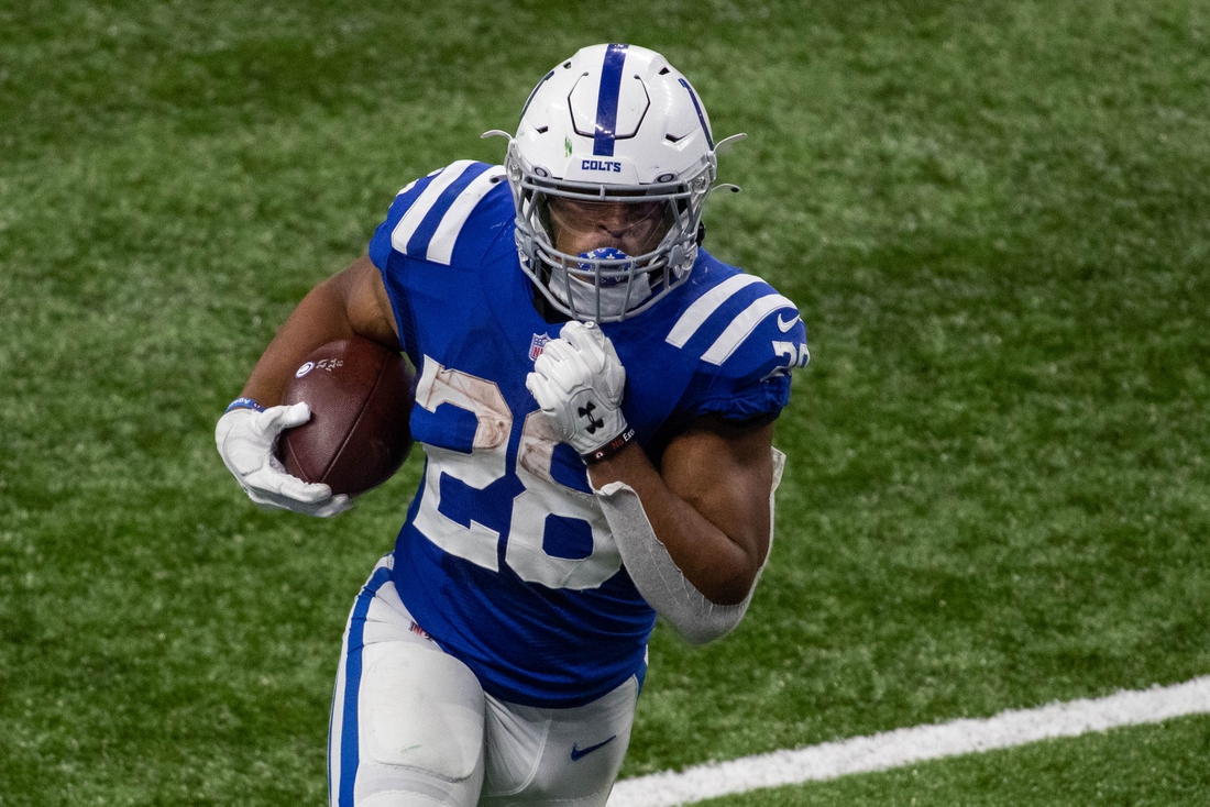 Nov 22, 2020; Indianapolis, Indiana, USA; Indianapolis Colts running back Jonathan Taylor (28) runs the ball in the second half against the Green Bay Packers at Lucas Oil Stadium. Mandatory Credit: Trevor Ruszkowski-USA TODAY Sports