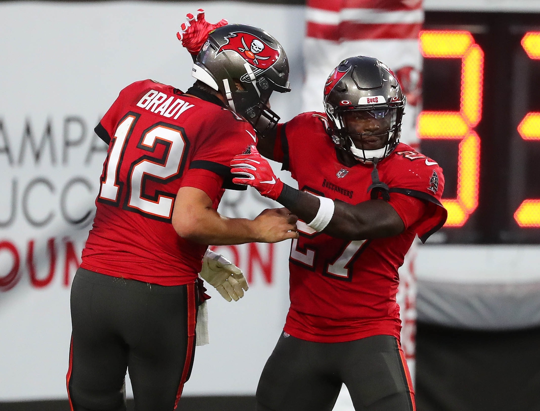 Nov 29, 2020; Tampa, Florida, USA; Tampa Bay Buccaneers quarterback Tom Brady (12) celebrates with running back Ronald Jones (27) his touchdown scored against the Kansas City Chiefs during the first half at Raymond James Stadium. Mandatory Credit: Kim Klement-USA TODAY Sports