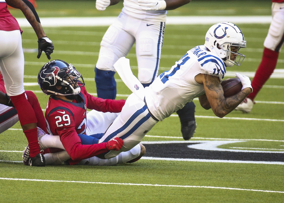 Dec 6, 2020; Houston, Texas, USA; Indianapolis Colts wide receiver Michael Pittman (11) makes a reception as Houston Texans cornerback Phillip Gaines (29) attempts to make a tackle during the second quarter at NRG Stadium. Mandatory Credit: Troy Taormina-USA TODAY Sports