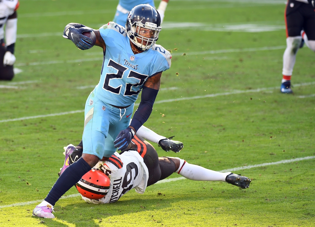 Dec 6, 2020; Nashville, Tennessee, USA; Tennessee Titans running back Derrick Henry (22) is tackled by Cleveland Browns cornerback Terrance Mitchell (39) after a short gain during the second half at Nissan Stadium. Mandatory Credit: Christopher Hanewinckel-USA TODAY Sports