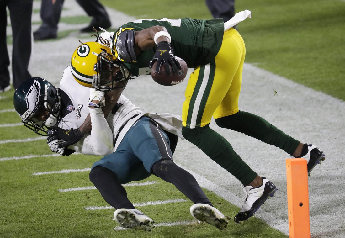 Dec 6, 2020; Green Bay, WI, USA;  Green Bay Packers wide receiver Davante Adams (17) scores a touchdown against Philadelphia Eagles cornerback Darius Slay (24) in the third quarter during their football game Sunday, December 6, 2020, at Lambeau Field in Green Bay, Wis.  Mandatory Credit: Dan Powers-USA TODAY NETWORK