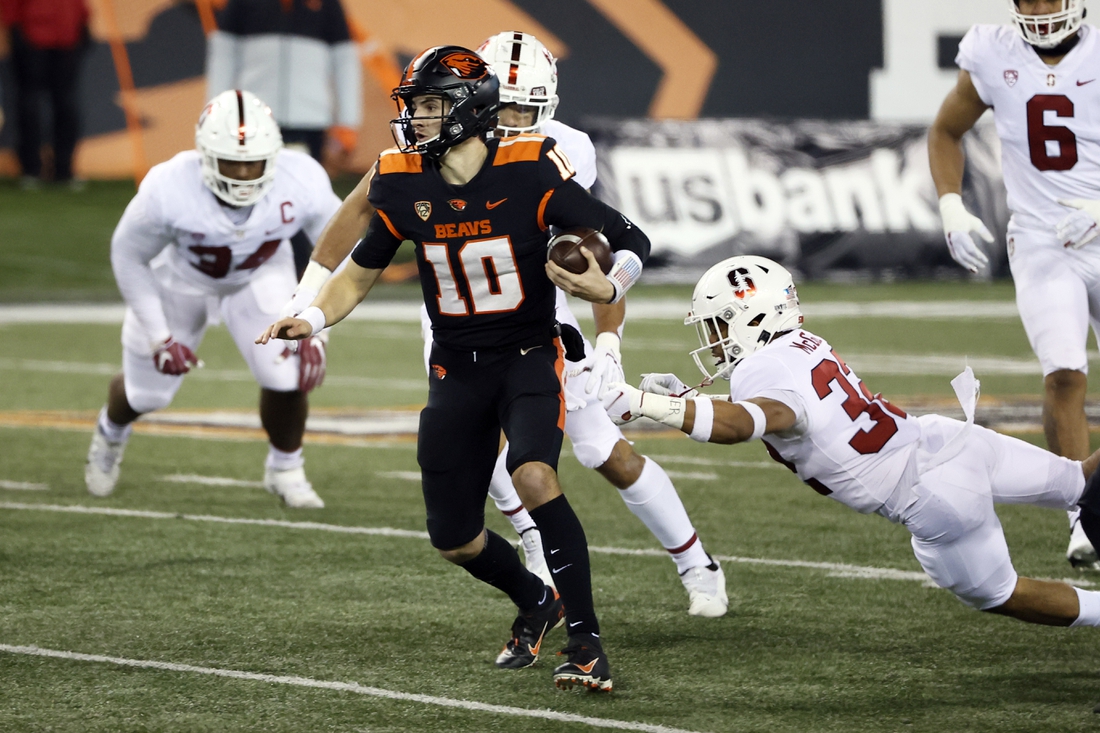 Dec 12, 2020; Corvallis, Oregon, USA; Oregon State Beavers quarterback Chance Nolan (10) scrambles out of the pocket to pass against the Stanford Cardinal during the first half at Reser Stadium. Mandatory Credit: Soobum Im-USA TODAY Sports