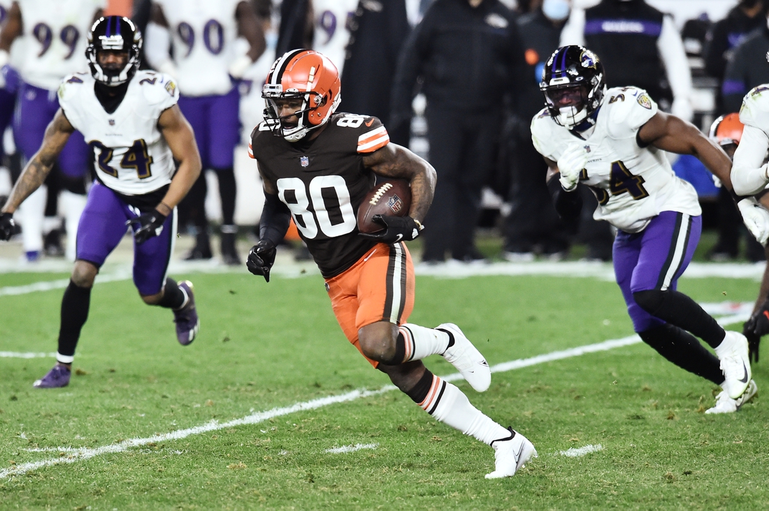 Dec 14, 2020; Cleveland, Ohio, USA; Cleveland Browns wide receiver Jarvis Landry (80) runs with the ball after a catch as Baltimore Ravens cornerback Marcus Peters (24) and linebacker Tyus Bowser (54) defend during the second half at FirstEnergy Stadium. Mandatory Credit: Ken Blaze-USA TODAY Sports